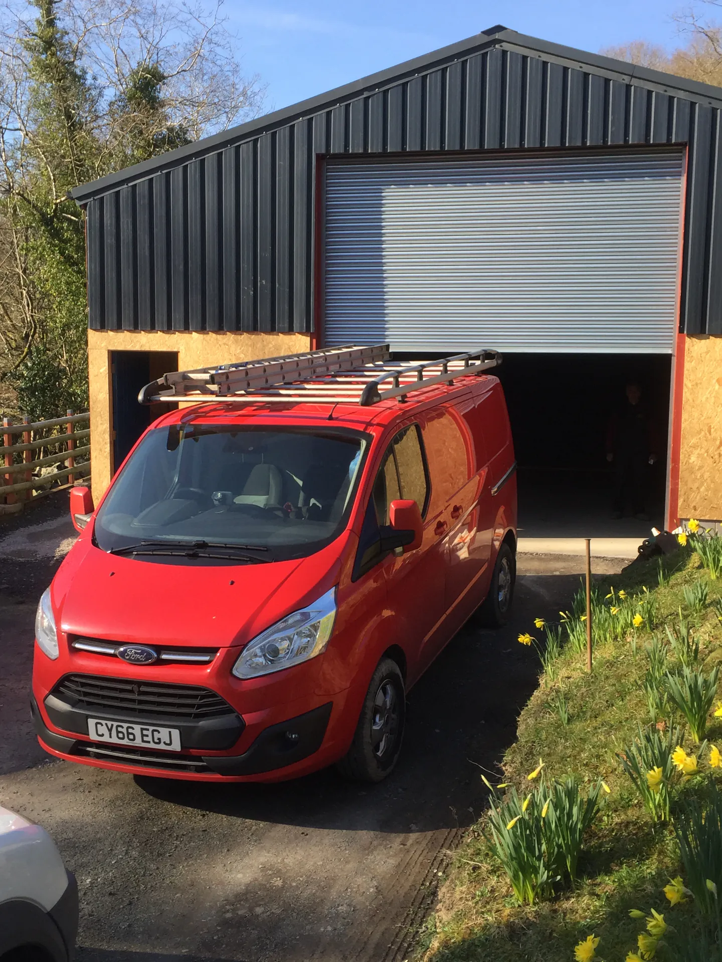 SteeLee van parked outside a unit with its roller shutter door open